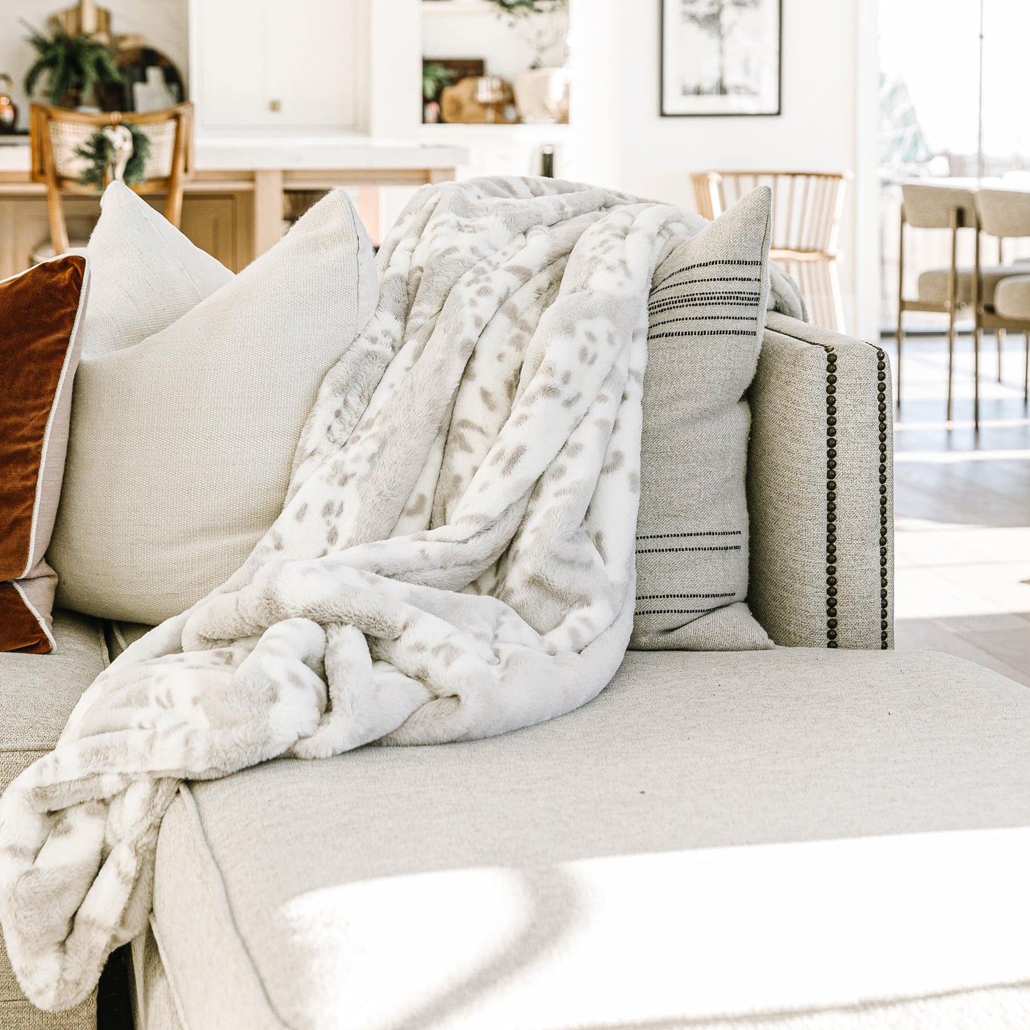 Arctic Lynx Minky Blanket draped elegantly over a couch in a modern living room